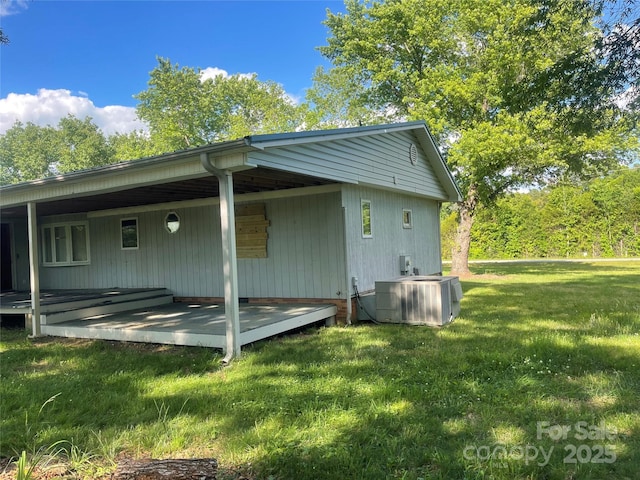 view of property exterior with central AC unit and a yard