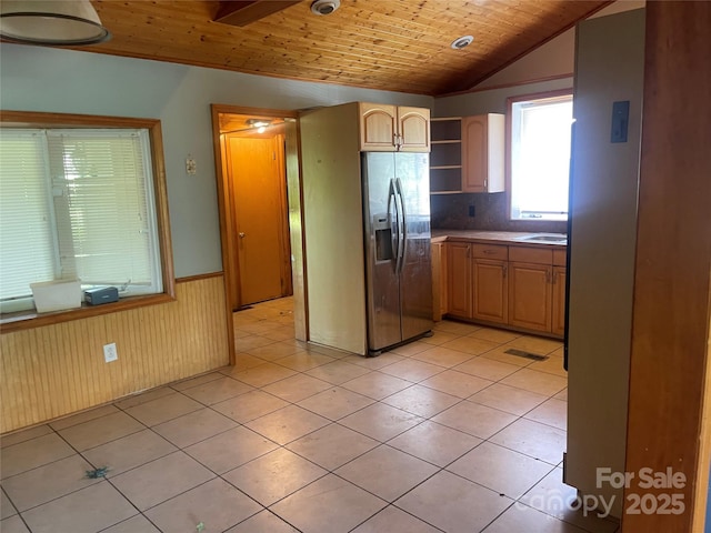 kitchen with stainless steel fridge with ice dispenser, wood ceiling, open shelves, wainscoting, and light tile patterned floors