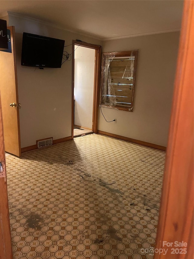 spare room featuring crown molding
