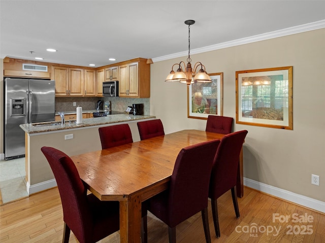 401 Bowling Park Rd, Asheville, NC 28803 - dining area with crown molding, light wood-style floors, a chandelier, baseboards, and recessed lighting