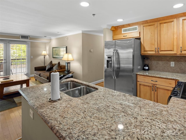 401 Bowling Park Rd, Asheville, NC 28803 - kitchen featuring light stone countertops, light wood-style flooring, stainless steel fridge with ice dispenser, a sink, and crown molding