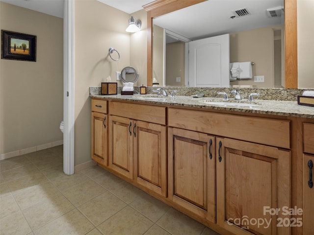 401 Bowling Park Rd, Asheville, NC 28803 - bathroom featuring tile patterned floors, visible vents, toilet, and a sink