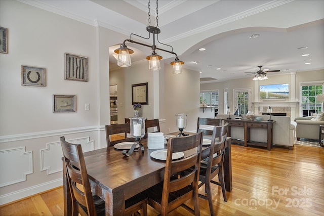 7471 Barfield Ln, Denver, NC 28037 - dining room with ceiling fan, light wood finished floors, recessed lighting, a fireplace, and crown molding