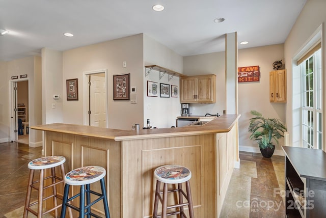 7471 Barfield Ln, Denver, NC 28037 - kitchen with baseboards, light brown cabinets, recessed lighting, a breakfast bar, and a sink
