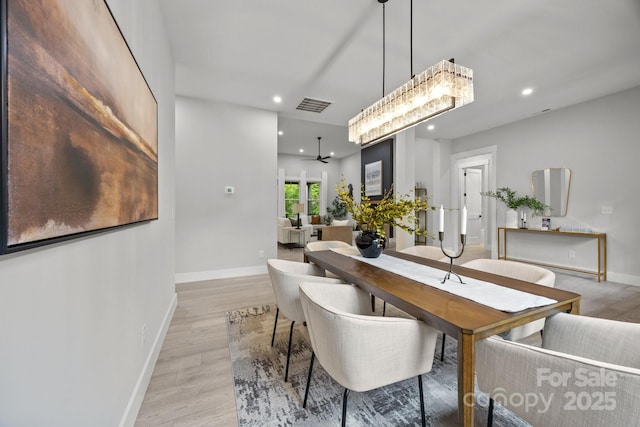 dining space with recessed lighting, visible vents, light wood-style flooring, baseboards, and ceiling fan with notable chandelier