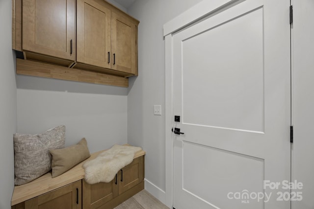 mudroom with light wood-style floors and baseboards