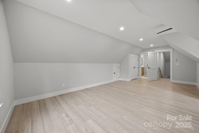 bonus room featuring baseboards, recessed lighting, light wood-style floors, and vaulted ceiling