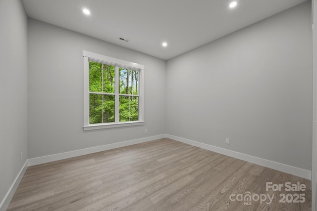 unfurnished room featuring baseboards, recessed lighting, and light wood-style flooring