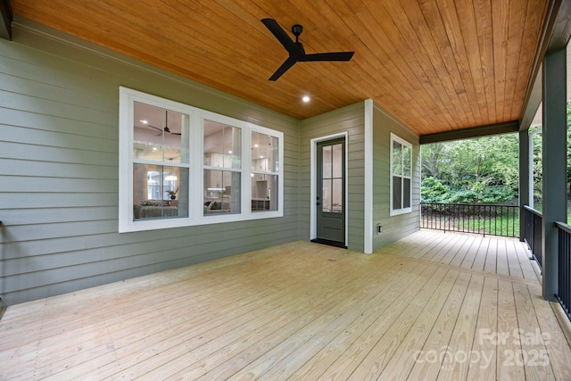 wooden terrace with ceiling fan and a porch