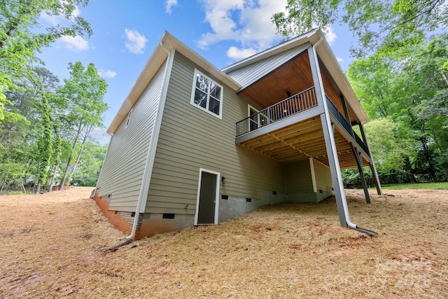 rear view of property with a deck and crawl space