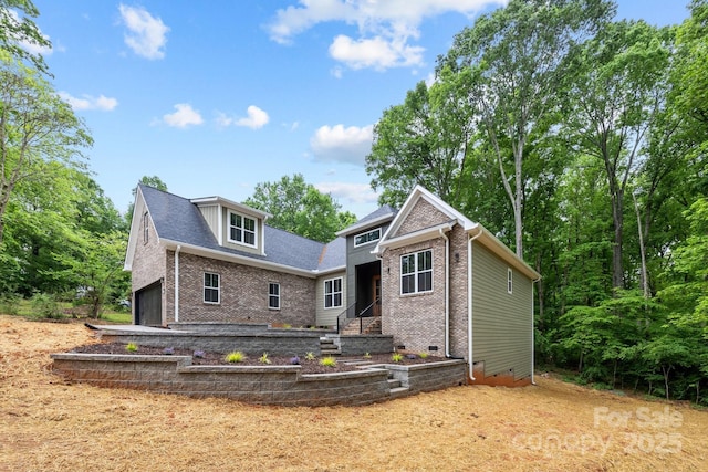 rear view of property featuring crawl space and brick siding