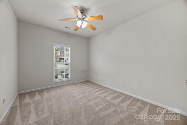 8313 Carob Tree Ln, Charlotte, NC 28215 - spare room with light colored carpet, baseboards, and ceiling fan