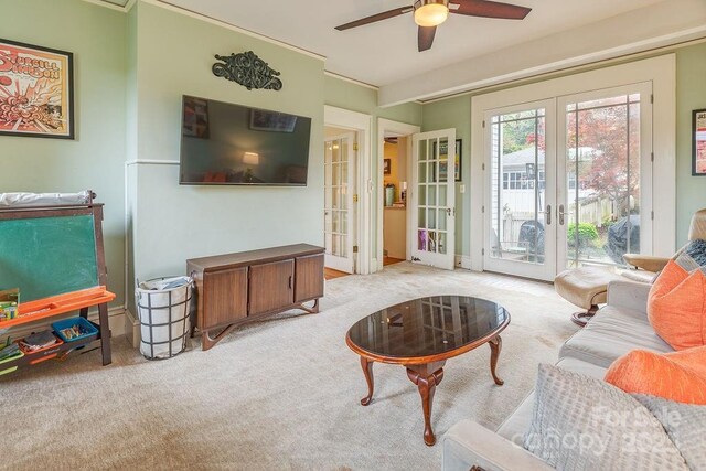 living room featuring french doors, light colored carpet, and a ceiling fan