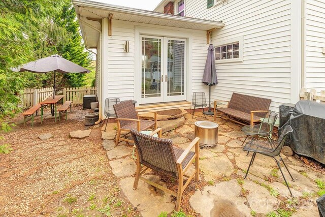 view of patio / terrace featuring french doors and fence