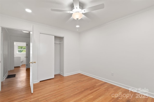 1294 Beaverdam Rd, Canton, NC 28716 - unfurnished bedroom featuring visible vents, crown molding, baseboards, a closet, and light wood-style floors