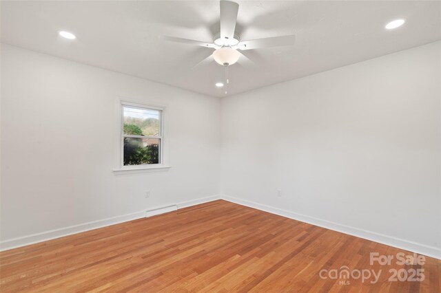 1294 Beaverdam Rd, Canton, NC 28716 - unfurnished room with light wood-style floors, baseboards, a ceiling fan, and visible vents