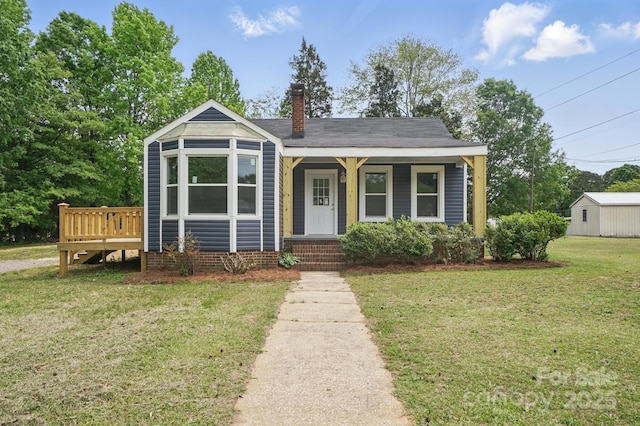 410 E 17th St, Kannapolis, NC 28083 - bungalow-style house with a porch, a chimney, and a front lawn