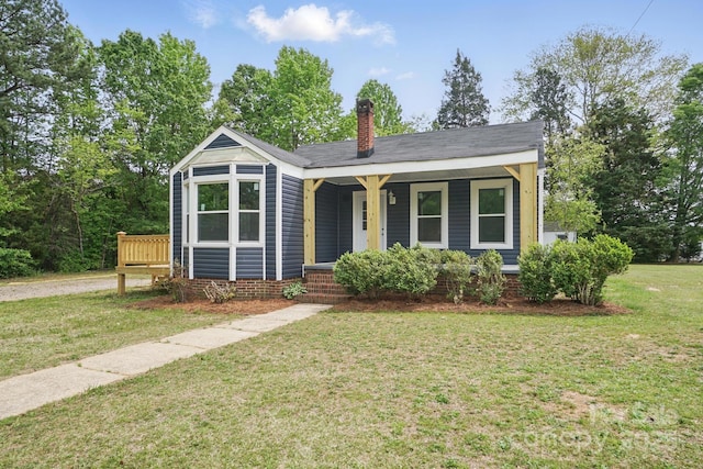 410 E 17th St, Kannapolis, NC 28083 - bungalow featuring a porch, a chimney, and a front yard