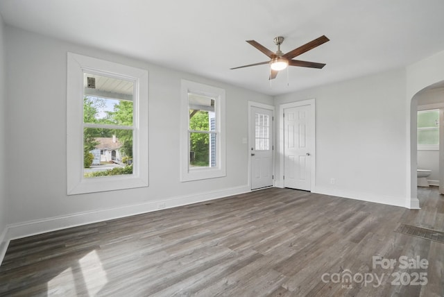 410 E 17th St, Kannapolis, NC 28083 - interior space featuring ceiling fan, arched walkways, wood finished floors, and baseboards