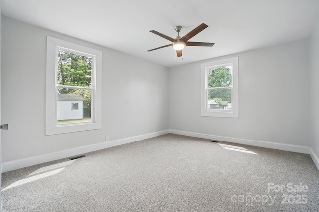 410 E 17th St, Kannapolis, NC 28083 - carpeted empty room with baseboards, visible vents, and ceiling fan
