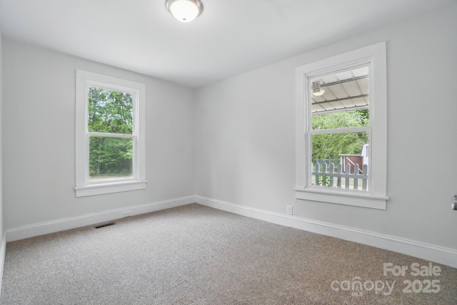 410 E 17th St, Kannapolis, NC 28083 - empty room featuring carpet floors, visible vents, and baseboards