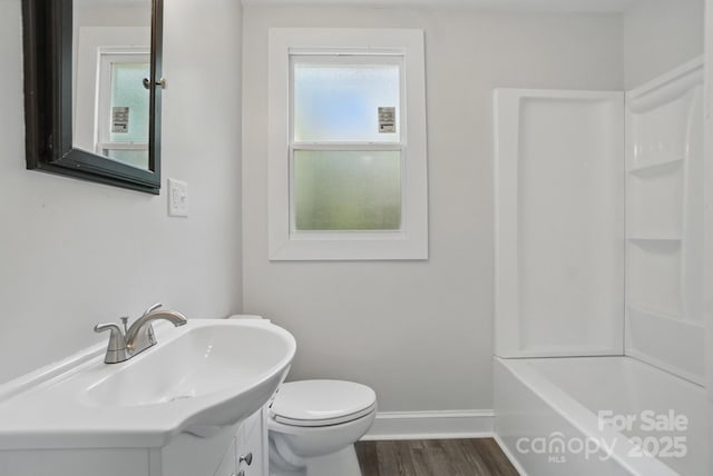 410 E 17th St, Kannapolis, NC 28083 - full bath with wood finished floors, vanity, toilet, and baseboards