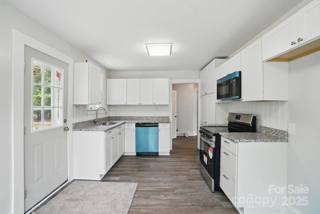 410 E 17th St, Kannapolis, NC 28083 - kitchen with dark wood-style floors, dishwashing machine, a sink, black microwave, and stainless steel electric stove