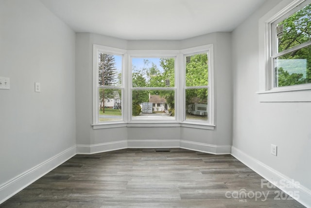 410 E 17th St, Kannapolis, NC 28083 - empty room featuring wood finished floors, visible vents, and baseboards