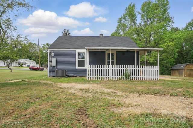 410 E 17th St, Kannapolis, NC 28083 - view of front facade featuring fence, central air condition unit, an outdoor structure, a storage unit, and a front yard
