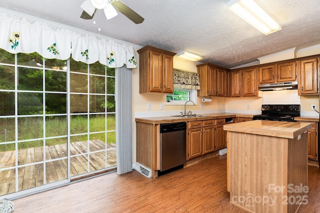 kitchen featuring black electric range oven, a sink, wood counters, dishwasher, and under cabinet range hood