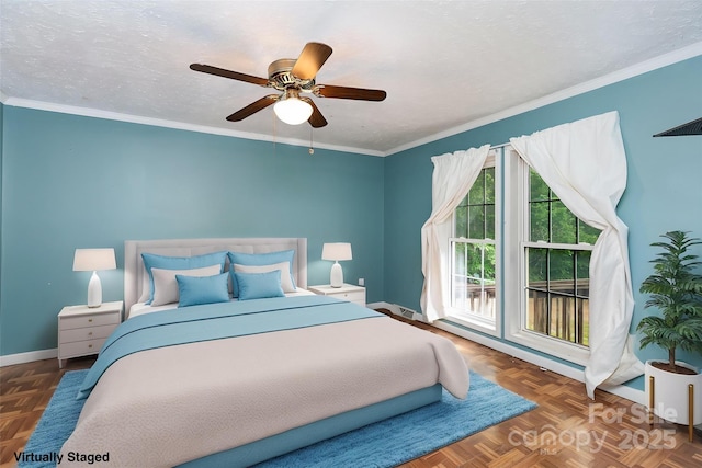 bedroom featuring baseboards, crown molding, and a ceiling fan