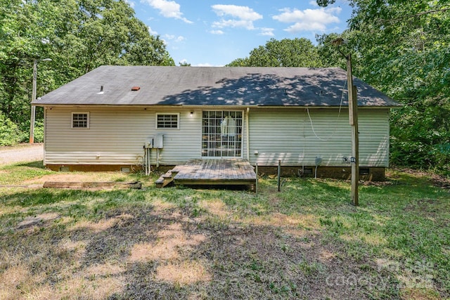 rear view of house featuring crawl space, a wooden deck, and a shingled roof