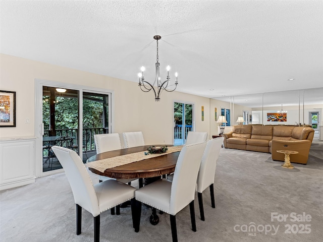 dining room with light carpet, a notable chandelier, and a healthy amount of sunlight