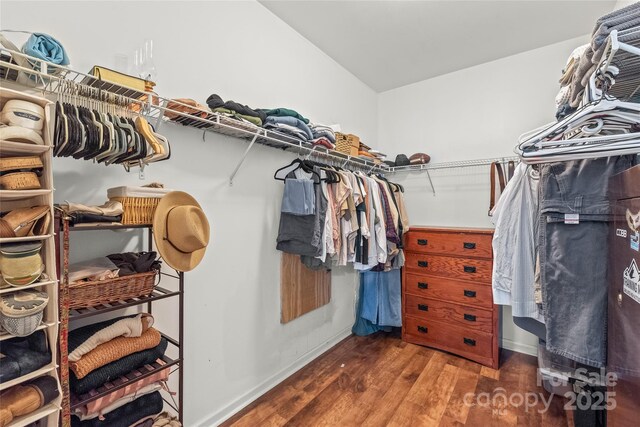 spacious closet with vaulted ceiling and wood finished floors