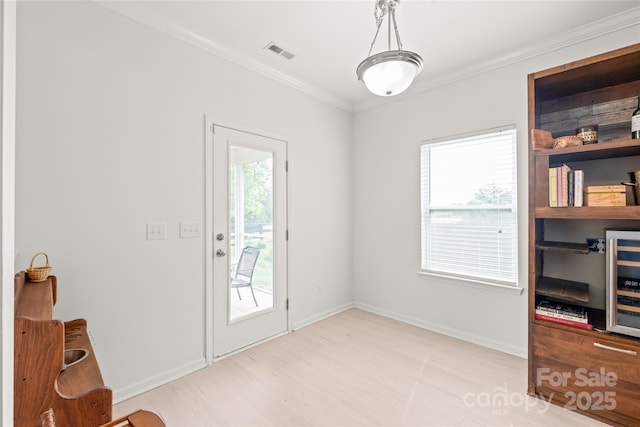 306 Fesperman Cir, Troutman, NC 28166 - doorway featuring ornamental molding, wine cooler, and wood finished floors