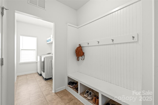306 Fesperman Cir, Troutman, NC 28166 - mudroom with washer and clothes dryer and baseboards