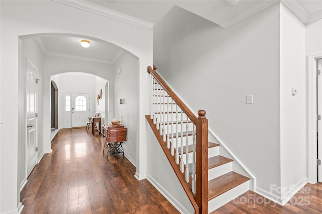 306 Fesperman Cir, Troutman, NC 28166 - foyer with arched walkways, stairs, dark wood finished floors, and crown molding