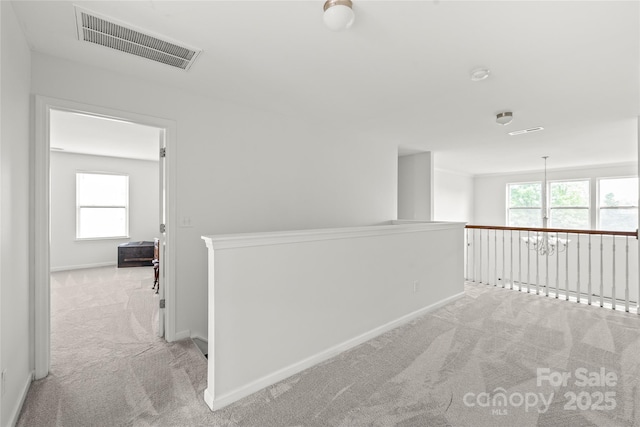 306 Fesperman Cir, Troutman, NC 28166 - hall with light colored carpet, an upstairs landing, and healthy amount of natural light