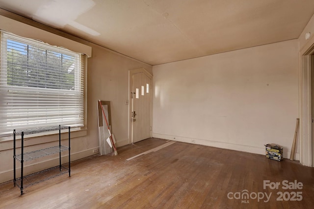 interior space featuring wood finished floors and baseboards