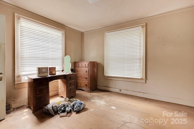 bedroom featuring light wood-style floors and ornamental molding