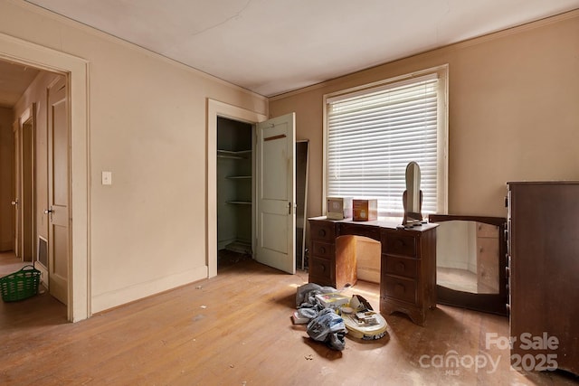 bedroom featuring light wood-style flooring and crown molding