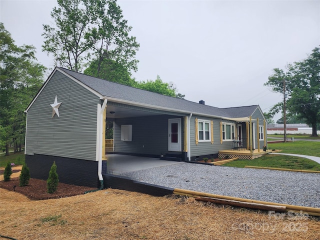 501 N Hawthorne St, Mount Holly, NC 28120 - view of side of home with driveway, crawl space, and an attached carport