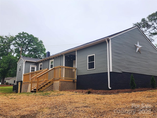 501 N Hawthorne St, Mount Holly, NC 28120 - back of property featuring a chimney and a wooden deck