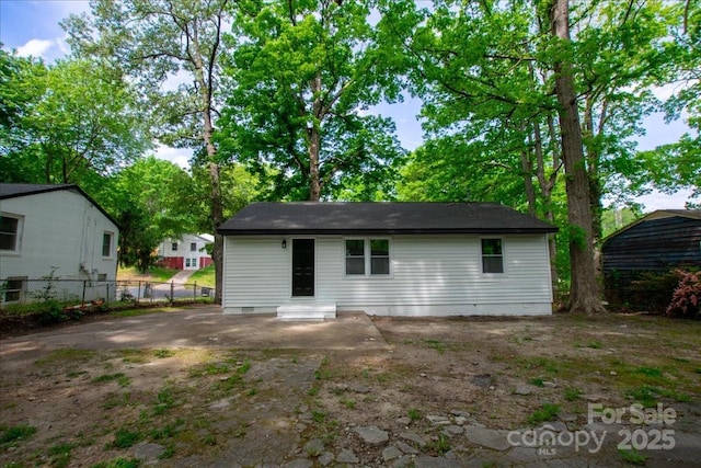back of house featuring fence, a patio area, and crawl space