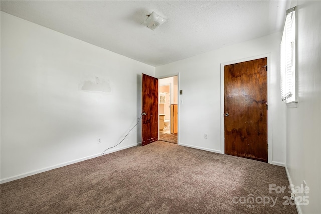 unfurnished bedroom featuring carpet floors and baseboards