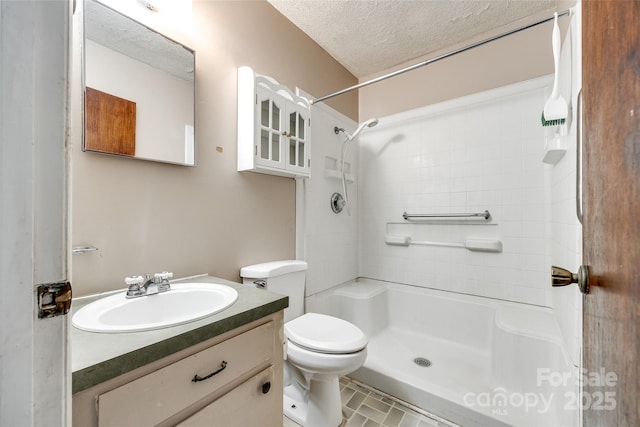 full bath featuring a textured ceiling, walk in shower, toilet, and vanity
