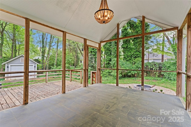 unfurnished sunroom with an inviting chandelier