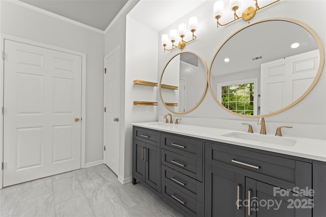 bathroom with ornamental molding, marble finish floor, double vanity, and a sink