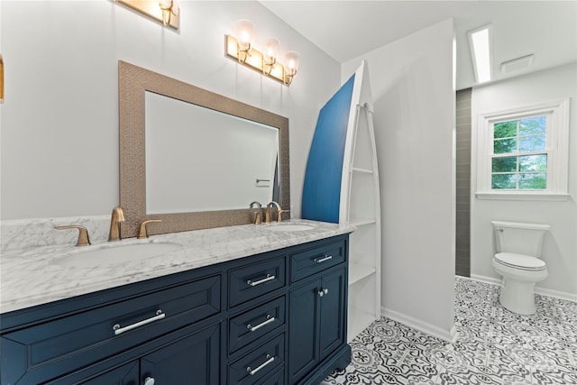 full bath with tile patterned floors, toilet, double vanity, and a sink