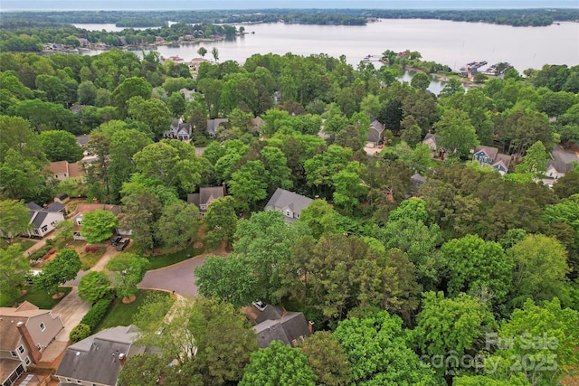 birds eye view of property with a water view and a residential view